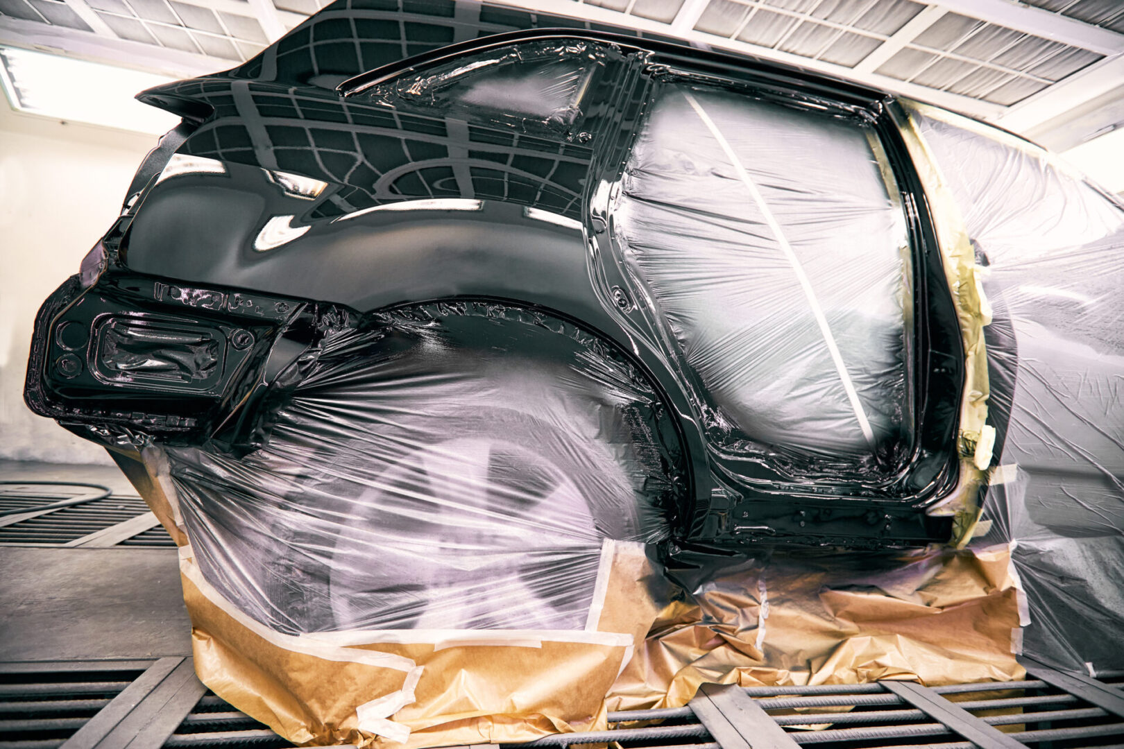 The Body of a Car Wrapped in Plastic for Repair
