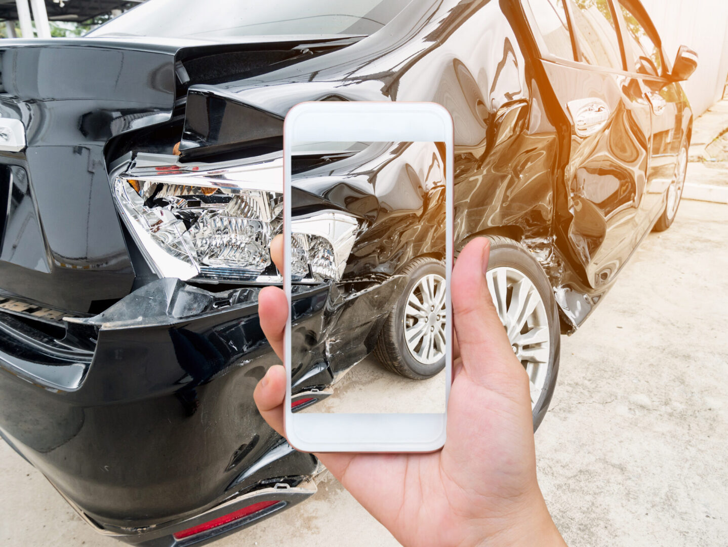 female hold mobile smartphone photographing car accident for insurance