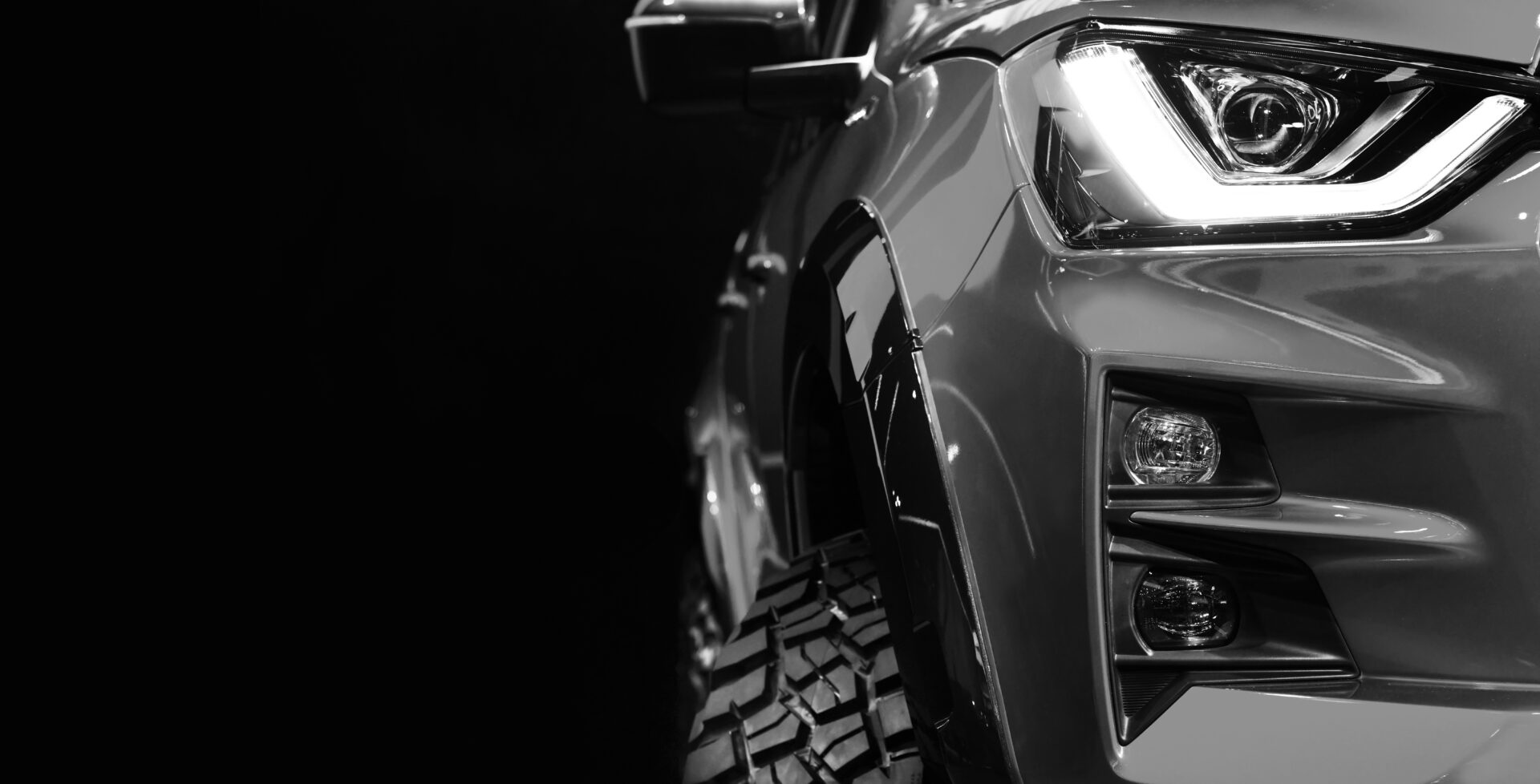 Close up detail on one of the LED headlights Pickup Truck black